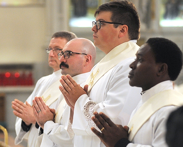 Father Gerard Skrzynski (from left), Father Peter Santandreu, Father Paul Stanislaw Cygan, Father Peter Nsa Bassey stand before the altar during a Ordination Mass at St. Joseph Cathedral. (Dan Cappellazzo/Staff Photographer)